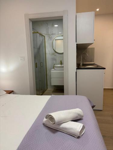 a bedroom with a bed with two towels on it at Apartment Hortenzija in Baška Voda