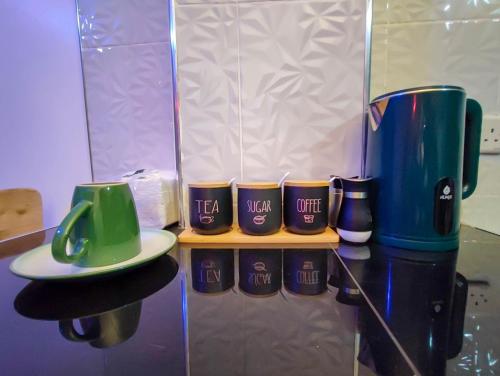 a group of coffee cups on a shelf at Kiriview Apartments in Nanyuki
