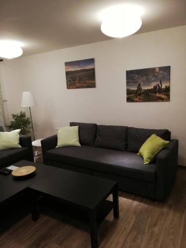 a living room with a couch and a table at Apartmány pod Divadlem in Znojmo