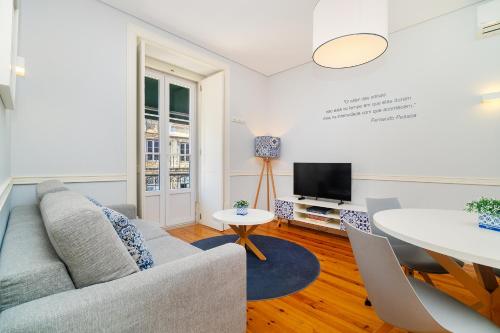a living room with a couch and a table at Villa Baixa - Lisbon Luxury Apartments in Lisbon