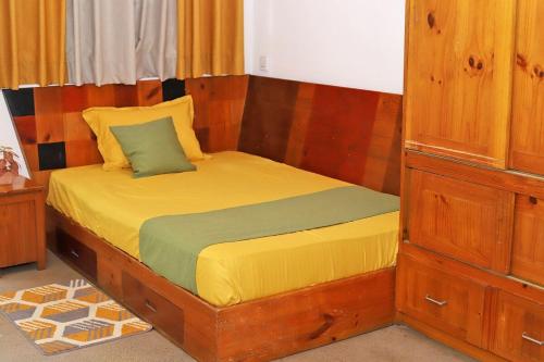 a bedroom with a bed with a wooden frame at 3 Bed Room Villa near Colombo in Kiribathgoda