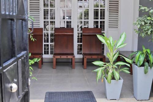 a group of chairs and plants on a porch at 3 Bed Room Villa near Colombo in Kiribathgoda