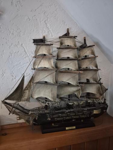 a model of a pirate ship on a table at Refuge du Poète in Longueuil