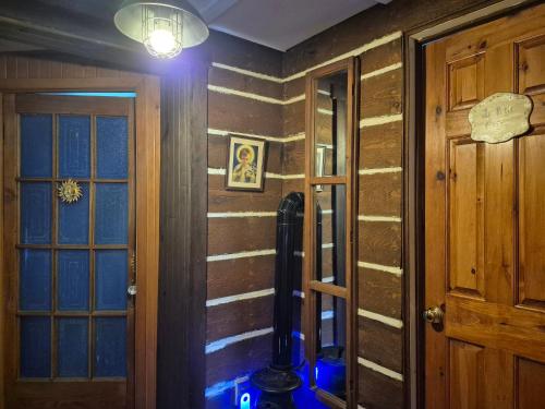 a hallway with a room with wooden walls and a lamp at Refuge du Poète in Longueuil