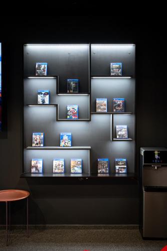 a shelf with photos on it in a room at Luna Self Check-in Hotel Klaipeda in Klaipėda