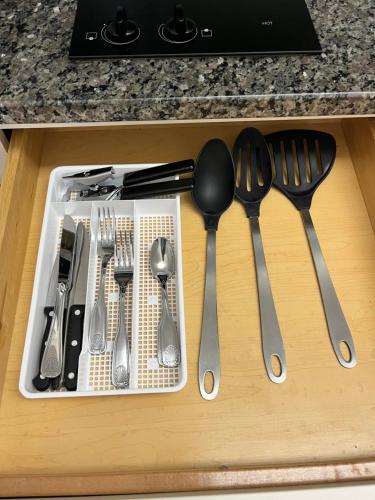 a tray of utensils sitting on top of a counter at MainStay Suites Sterling near Dulles Town Center in Sterling