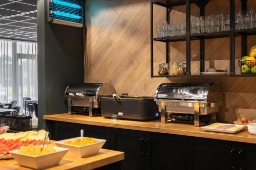 a kitchen with a counter with fruit on it at Luna Self Check-in Hotel Klaipeda in Klaipėda