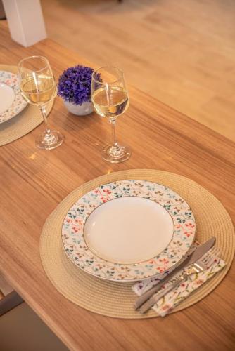 a table with a plate and two glasses of wine at Anamniseis Giorgio Falasarna in Plátanos