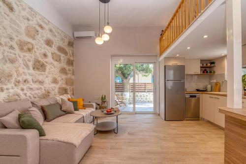 a living room with a couch and a table at Anamniseis Giorgio Falasarna in Plátanos