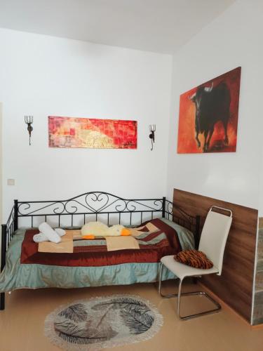 a bedroom with a bed and a chair at Charly's Home in Villach