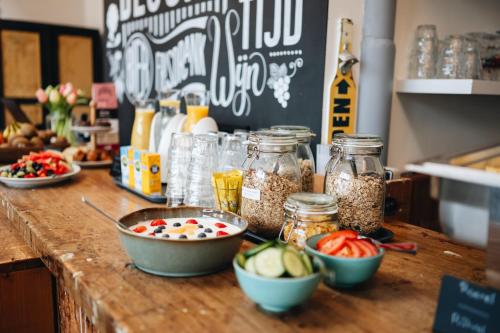 a counter with bowls of food and jars of nuts at Hotel Blooker in Renesse