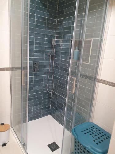 a bathroom with a shower with a glass door at O AL da Baixa in Figueira da Foz