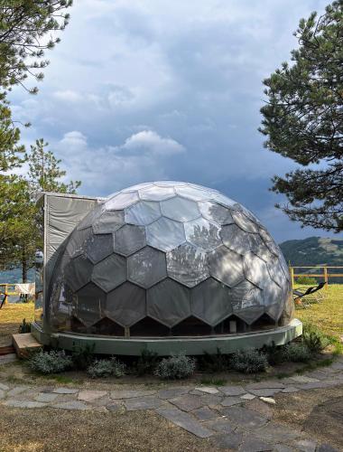 a sculpture of a soccer ball sitting in a field at Bubble Room Experience in Casteldelci