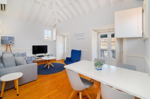 a living room with a white table and a couch at Villa Baixa - Lisbon Luxury Apartments in Lisbon