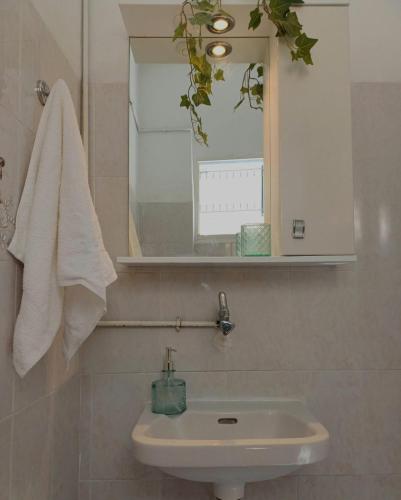 a bathroom with a sink and a mirror at Total Blue Maisonette in Koroni