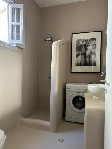 a bathroom with a washing machine and a sink at Villa Iza in Skala