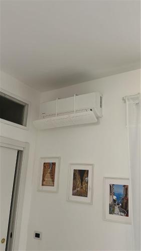 a white room with pictures and a white ceiling at GM Family in Siderno Marina