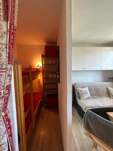 a small room with a bed and a closet at Studio puy saint Vincent in Puy-Saint-Vincent