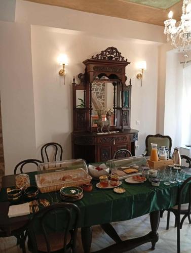 a table with a green table cloth with food on it at ARCHONTIKO HOTEL Kalymnos in Kalymnos