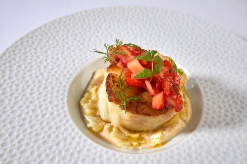 a plate of food on a white plate at Le Château de la Tour in Gouvieux