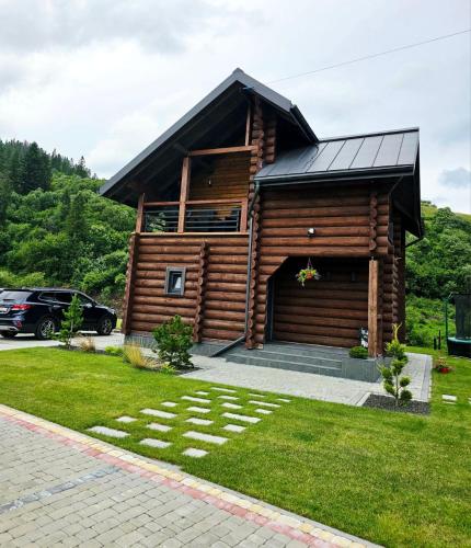 a log cabin with a gambrel roof at Cottage MiniHouse in Kozevo