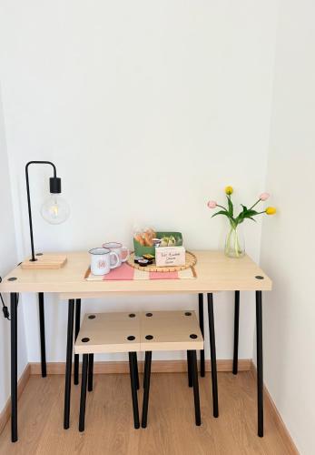 a wooden table with a vase of flowers on it at GM Family in Siderno Marina