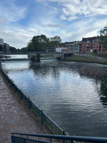 a body of water with a bridge and buildings at Terrassenwohnung City an der Kleinen Weser in Bremen