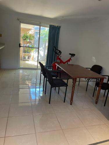 a dining room with a table and some chairs at Close to shops & airport in Perth