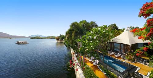 a view of a river with a building next to the water at The Leela Palace Udaipur in Udaipur