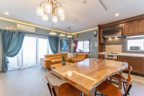 a kitchen and living room with a wooden dining room table at kizahashi-south-Osaka 200m2 family 5bedroom tabletennis in Osaka