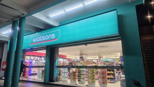 a woolworths store with a person walking through the window at PD D'Wharf High Floor Studio With Private Entrance And Seaview Balcony in Port Dickson