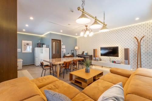 a living room with a couch and a table at kizahashi-south-Osaka 200m2 family 5bedroom tabletennis in Osaka