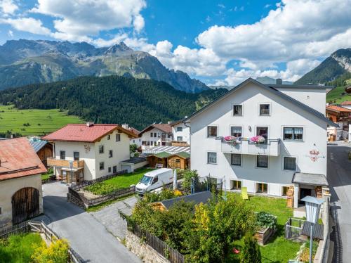a village in the mountains with a white house at Apart Moriggl in Nauders