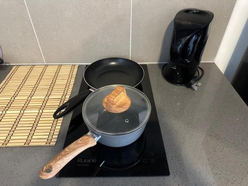 a pancake is cooking in a pot on a stove at Alinea suites Luxury near by shah alam in Shah Alam