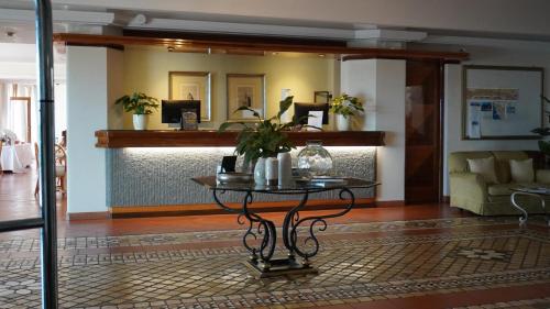 a living room with a table and a couch at Relais Santa Chiara Hotel - Tuscany Charme in San Gimignano