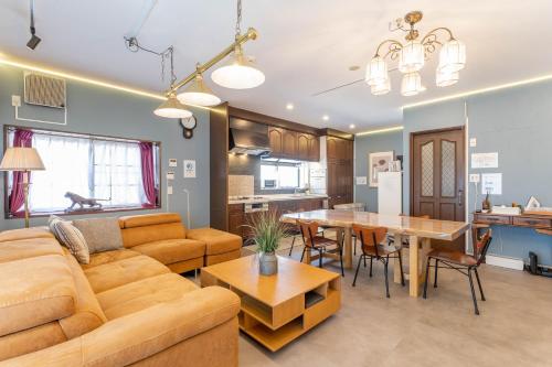 a living room with a couch and a table at kizahashi-south-Osaka 200m2 family 5bedroom tabletennis in Osaka