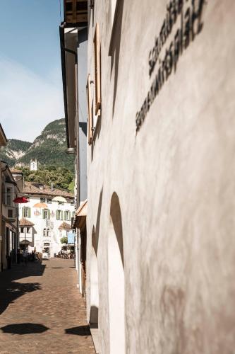 an empty street in a town with a building at Schmitte am Sonnenwirtsplatz Eppan in South Tyrol in Appiano sulla Strada del Vino