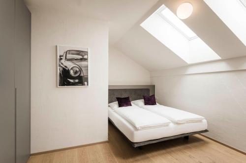 a bedroom with a bed and a picture of a car at Schmitte am Sonnenwirtsplatz Eppan in South Tyrol in Appiano sulla Strada del Vino