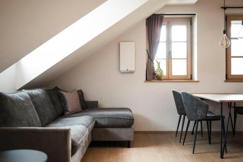 a living room with a couch and a table at Schmitte am Sonnenwirtsplatz Eppan in South Tyrol in Appiano sulla Strada del Vino
