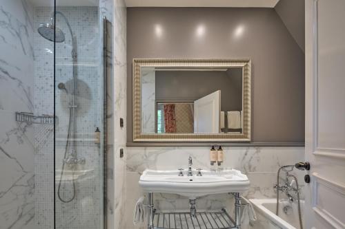 a bathroom with a sink and a shower at Le Château de la Tour in Gouvieux