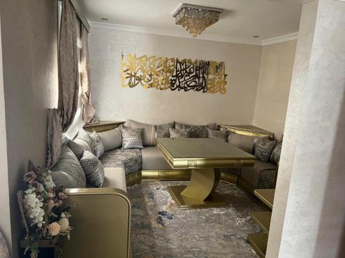 a living room with a couch and a table at Amira Hay Matar in Nador