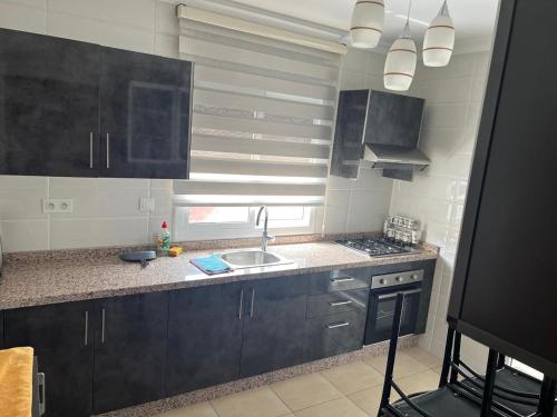 a kitchen with a sink and a counter top at Amira Hay Matar in Nador