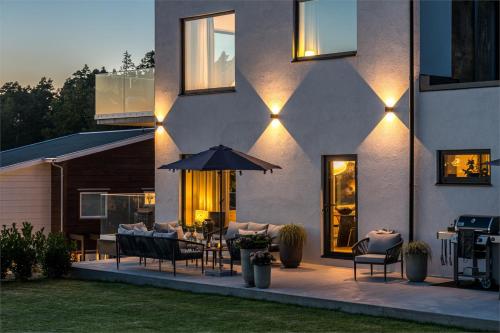 an outdoor patio with chairs and an umbrella at Villa Sund in Uddevalla