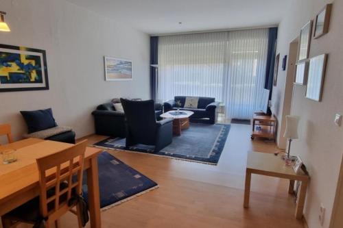 a living room with a couch and a table at Leuchtturmblick in Borkum