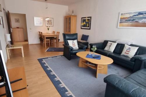 a living room with a couch and a table at Leuchtturmblick in Borkum