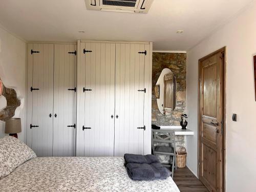 a bedroom with white cabinets and a bed and a sink at Historic Wine-Stone House in Vipava