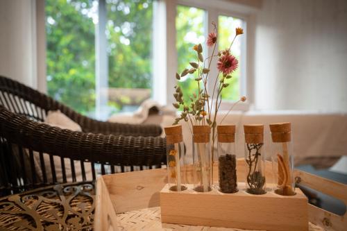a wooden table with a vase with flowers in it at Romantik Hotel Schweizerhof & Spa Flims in Flims