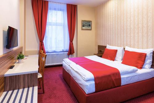 a hotel room with a large bed and a window at Hotel Continental in Plzeň