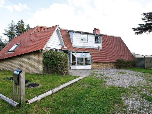 a house with a red roof and a yard at 7 person holiday home in Lemvig-By Traum in Trans