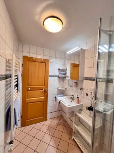 a bathroom with a sink and a shower and a mirror at Baalmann Nr.1 in Borkum